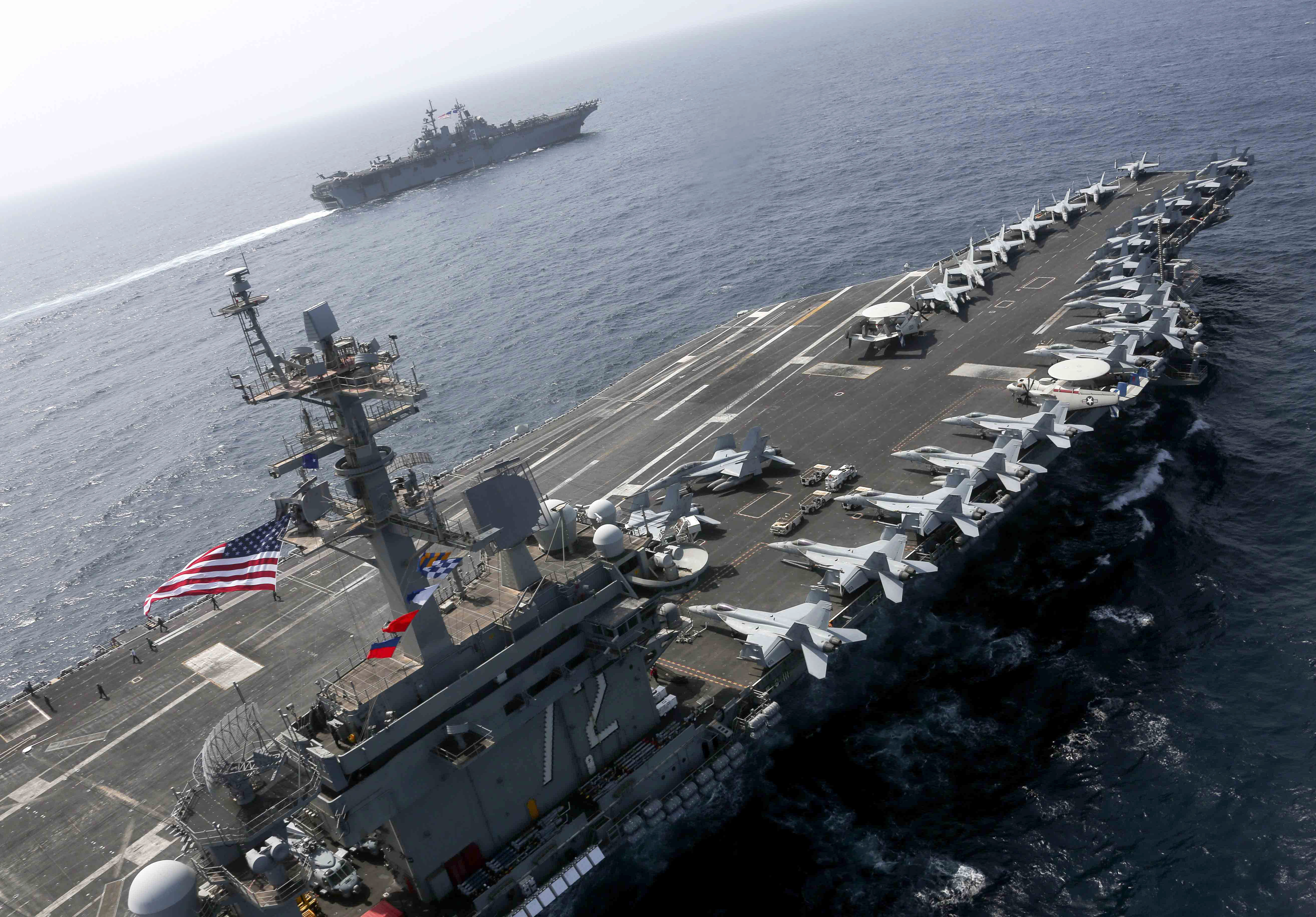 190517-N-FK070-1757ARABIAN SEA (May 17, 2019) The Nimitz-class aircraft carrier USS Abraham Lincoln (CVN 72) and the Wasp-class Amphibious Assault Ship USS Kearsarge (LHD 3) sail alongside as the Abraham Lincoln Carrier Strike Group (ABECSG) and Kearsarge Amphibious Ready Group (KSGARG) conduct joint operations in the U.S. 5th Fleet area of operations. The ABECSG and KSGARG, with the 22nd Marine Expeditionary Unit, are prepared to respond to contingencies and to defend U.S. forces and interests in the region. (U.S. Navy photo by Mass Communication Specialist 1st Class Brian M. Wilbur/Released)