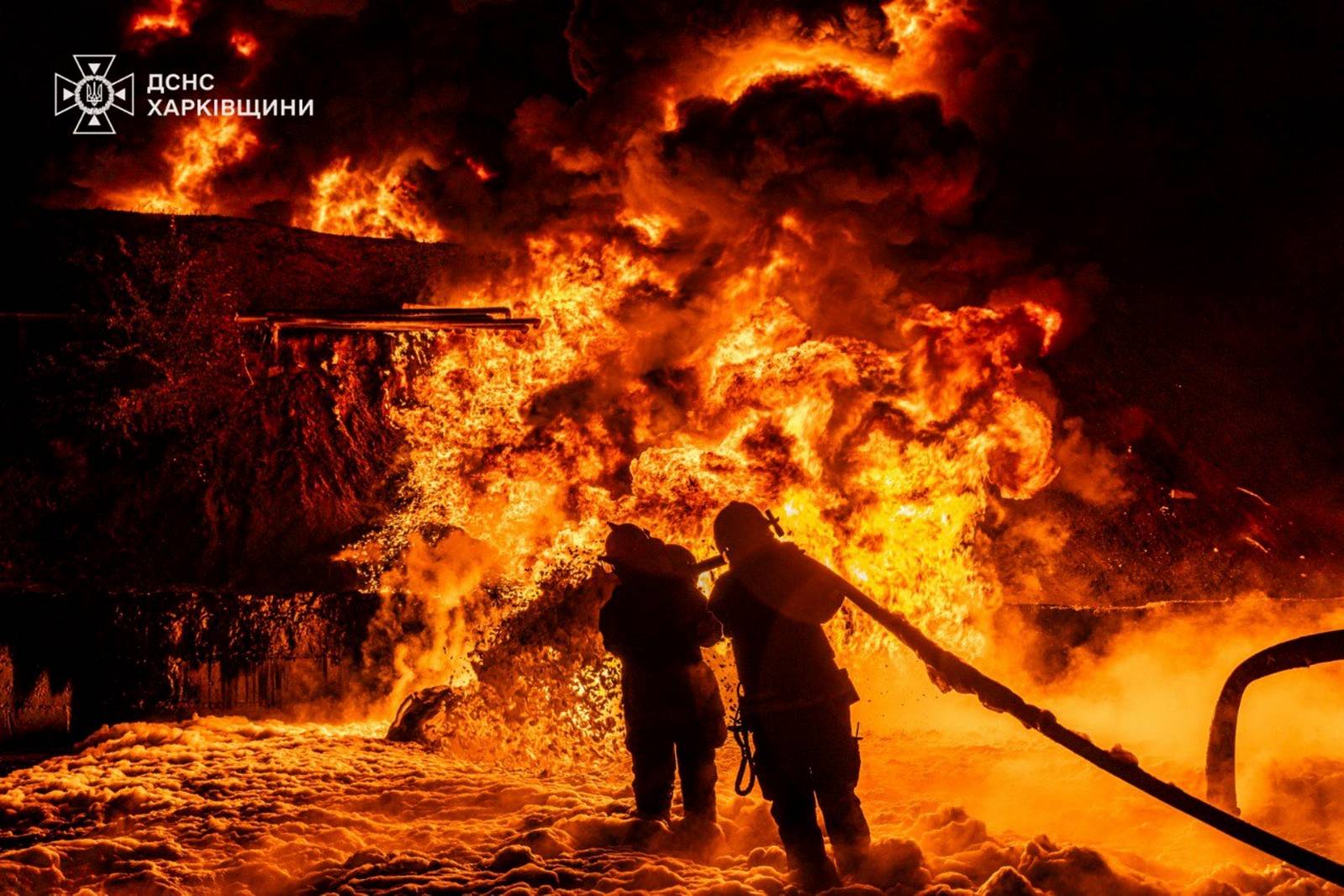 In this photo provided by the Ukrainian Emergency Service, emergency services personnel work to extinguish a fire following a Russian attack in Kharkiv region, Ukraine, Saturday, July 5, 2025. (Ukrainian Emergency Service via AP)